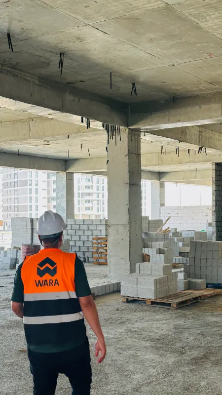 A Wara Construction worker walking under a finished slab